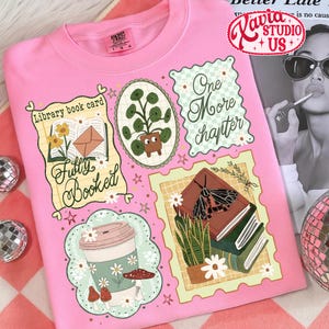 May include: Pink sweatshirt with various illustrated patches. Patches include a coffee cup, a potted plant, a stack of books with a moth, and the words "Fully Booked" and "One More Chapter". The sweatshirt also has the text "Xavia Studio US".