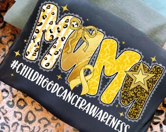 May include: A dark gray sweatshirt with the word "MOM" in yellow and leopard print, with a yellow ribbon and the text "#CHILDHOODCANCERAWARENESS". The design includes stars and a lace trim.