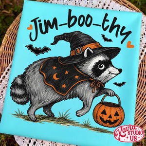 May include: A rectangular canvas print with a bright turquoise background featuring a gray raccoon wearing a black witch hat and cape with orange stars and a crescent moon. The text Jim-boo-thy is printed above, with three black bats and two orange hearts.