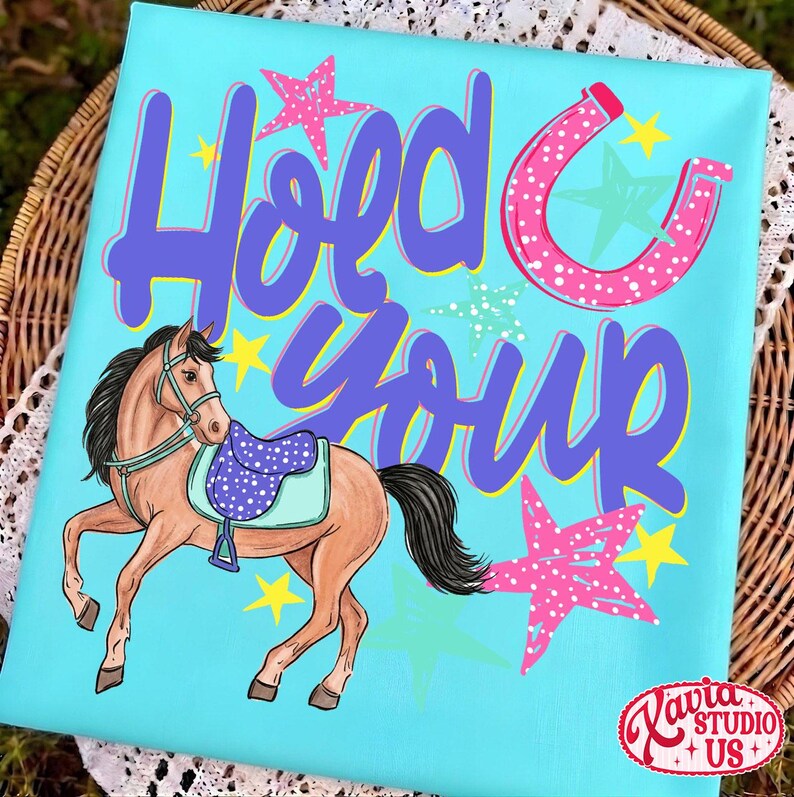 May include: A turquoise canvas with a cartoon horse wearing a saddle. The text "Hold Your" is in purple script, with a pink horseshoe and stars. The horse is brown with a black mane and tail. Yellow and pink stars are scattered around the horse and text.