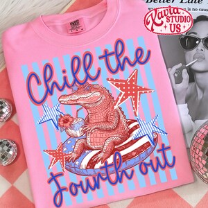 May include: Pink t-shirt with a graphic of an alligator wearing sunglasses, relaxing on a patriotic float, and holding a tropical drink. The text "Chill the Fourth out" is in blue and red. Stars and stripes complete the design.