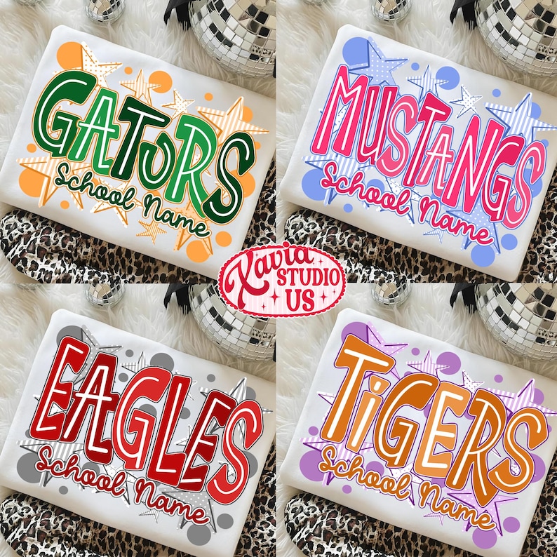 May include: Four white t-shirts with school names in bold, colorful fonts. The shirts feature the names "GATORS", "MUSTANGS", "EAGLES", and "TIGERS", each with a unique design and star accents. The shirts are displayed on a leopard print surface.