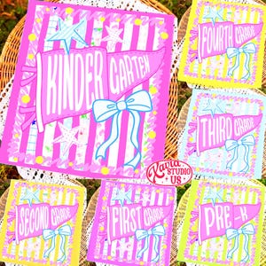 May include: A collection of rectangular graphic prints featuring pink pennants with white text for various school grades, including Kindergarten, Pre-K, and First through Fourth Grade. Each design includes a light blue bow and star accents.