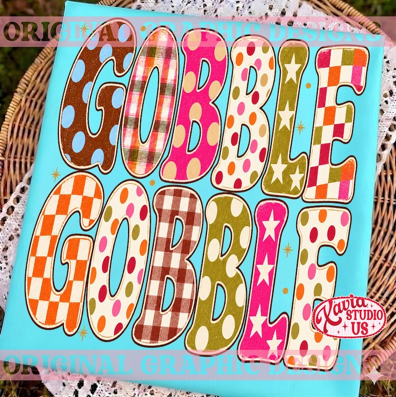 May include: A rectangular sign with a bright turquoise background featuring the text GOBBLE GOBBLE in large, stylized letters. Each letter displays a unique pattern including polka dots, plaid, checkered squares, and stars in various colors.