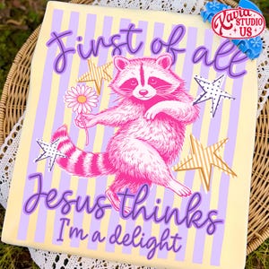 May include: A light yellow t-shirt with a raccoon illustration in pink and white, holding a daisy. The shirt has vertical stripes in yellow and lavender, with text that reads "First of all Jesus thinks I'm a delight."