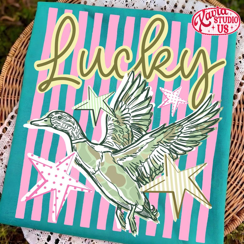 May include: A teal and pink striped canvas with the word "Lucky" in a cursive font. A green and white duck illustration is centered, with star accents. The canvas is from Kavia Studio US.
