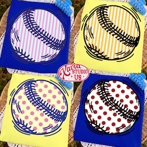 May include: Four baseball-themed t-shirts in blue and yellow. Each shirt features a baseball design with different patterns: pink stripes, yellow stripes, pink polka dots, and red polka dots. The shirts are arranged on a woven surface.