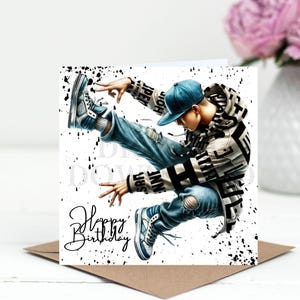 May include: A birthday card featuring a stylized illustration of a person in a hip-hop pose. The person is wearing a blue cap, ripped jeans, and a hooded jacket. The words "Happy Birthday" are written in cursive.