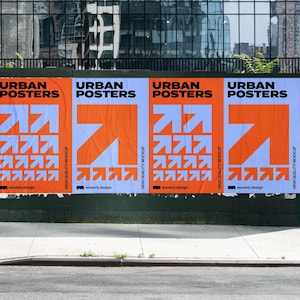 May include: Four orange and white posters with the text "URBAN POSTERS" and a graphic of a white arrow pointing upwards. The posters are mounted on a green wall.