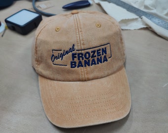 Festgehalten Entwicklung Bananenständer Cap