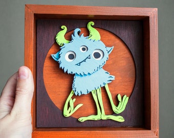 Blue funny alien nursery decor. Above kid bed hanging. 3D silly monster framed. Original wooden artwork for playroom