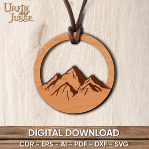 May include: A wooden pendant with a brown leather cord. The pendant is a circle with a mountain range silhouette inside. The pendant is a digital download file.