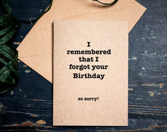 Puede incluir: Una tarjeta marrón con el texto "I remembered that I forgot your Birthday so sorry!" impreso en negro.