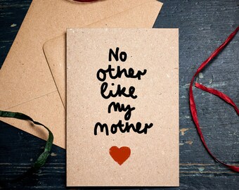 May include: A brown card with the text "No other like my mother" written in black ink. A red heart is drawn below the text.