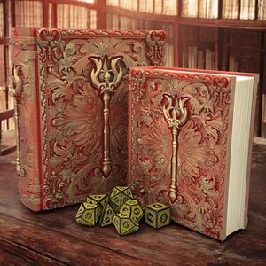 May include: Two ornate, red and gold books with intricate carvings and a key design. A set of yellow and black dice are in front of the books. The books are on a wooden surface, with a blurred library background.