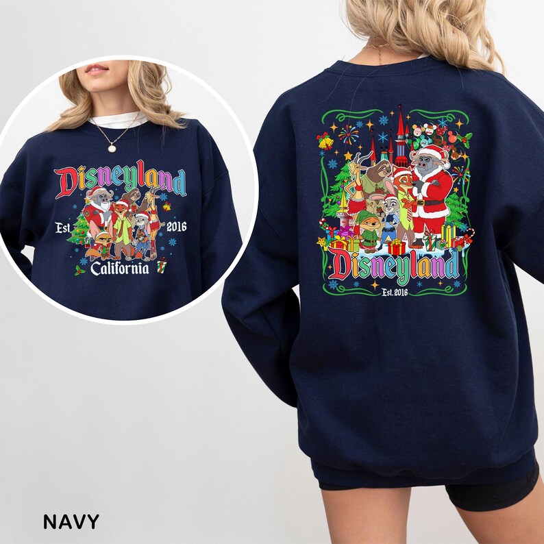 May include: Navy blue Disneyland sweatshirt with a colorful graphic on the front and back. The front graphic says "Disneyland California Est. 2016" with cartoon characters. The back graphic features a castle and more characters.