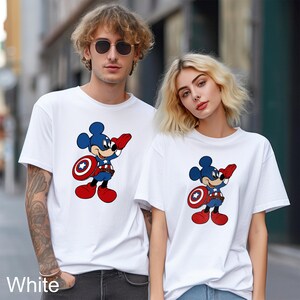 May include: White t-shirts featuring a cartoon Mickey Mouse dressed as Captain America. The character is depicted in blue, red, and white, holding a shield. The word "White" is printed at the bottom of the image.