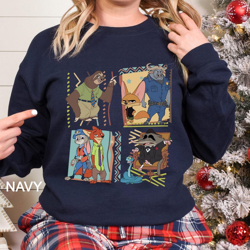 May include: Navy blue sweatshirt with a colourful graphic of animated movie characters. The design features a sloth, fox, bunny, and other characters in a square pattern. The word "NAVY" is printed on the bottom left.