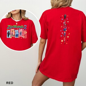 May include: Red t-shirt featuring the text "ZOOTOPIA 2" with cartoon characters on the front. The back of the shirt has a vertical design with more cartoon characters. The word "RED" is at the bottom of the image.