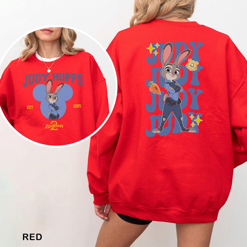 May include: Red sweatshirt featuring Judy Hopps from Zootopia. The front design includes the text "JUDY HOPPS" above a cartoon image of Judy Hopps inside a blue Mickey Mouse-shaped design. The back features a larger Judy Hopps graphic with the text "JUDY" repeated.