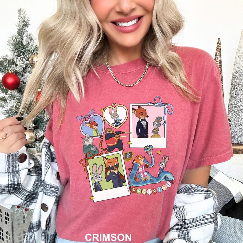 May include: Crimson t-shirt with a colourful graphic of Zootopia film characters. The design includes framed images of the characters, with the word "Zootopia" in a circular design. The shirt is a crew neck and the word "CRIMSON" is at the bottom.