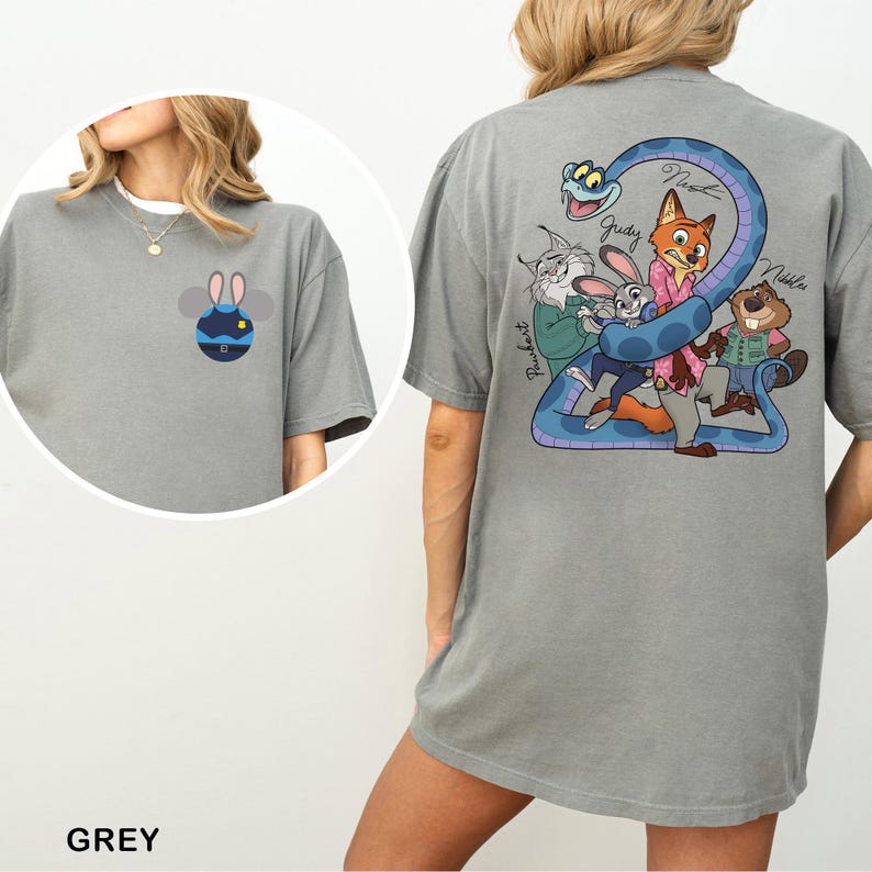 May include: Grey t-shirt featuring a cartoon bee design on the front and a colorful cartoon graphic on the back. The back graphic includes a blue snake and several cartoon characters. The word "Grey" is printed at the bottom.
