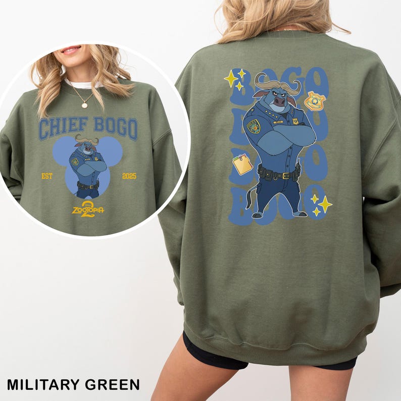 May include: Military green sweatshirt featuring a Chief Bogo graphic from Zootopia. The front design includes text and a cartoon image of Chief Bogo. The back of the sweatshirt has a larger graphic of Chief Bogo in a police uniform.
