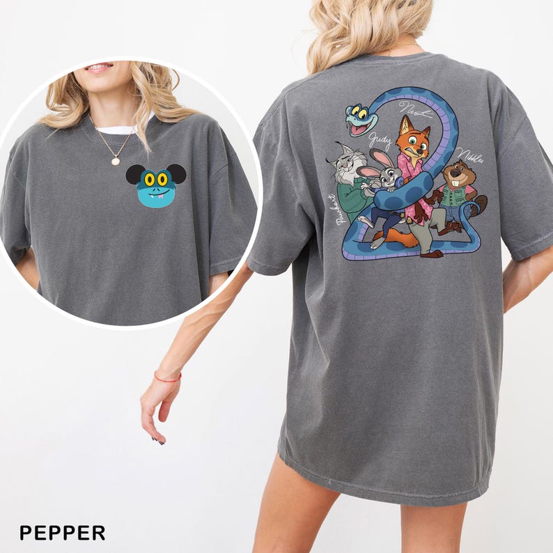 May include: Pepper-colored t-shirt featuring a cartoon character on the front and a Zootopia-themed graphic on the back. The back graphic includes Judy Hopps, Nick Wilde, and other characters. The shirt is a comfortable, oversized fit.