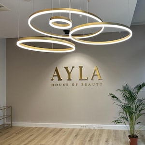 indoor sign.
made of stainless steel.
colour is brushed gold.
it is 1 inch away from the wall.
the letter thickness is 1 inch.