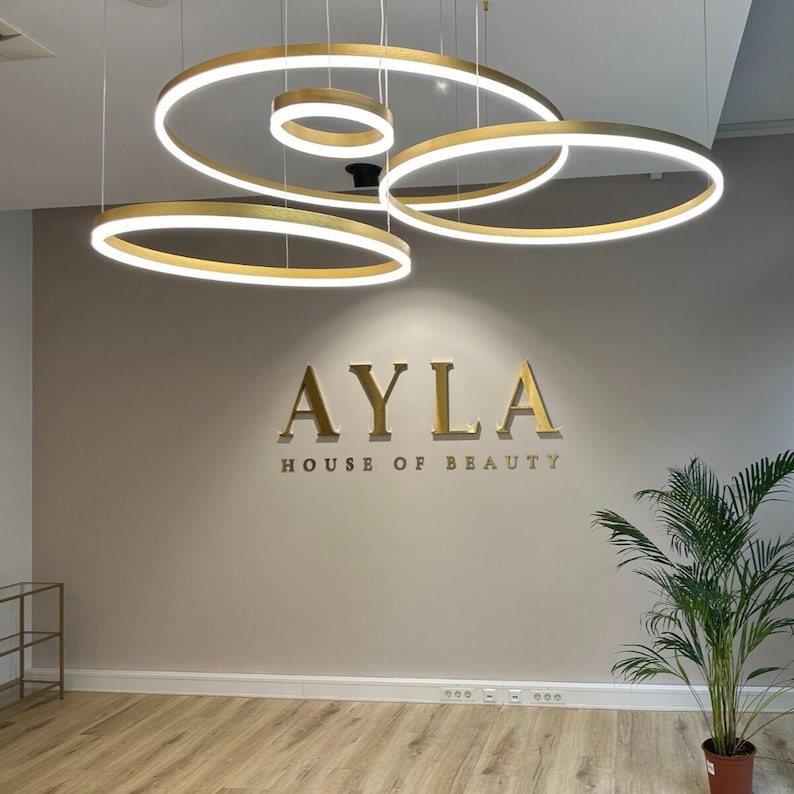 indoor sign.
made of stainless steel.
colour is brushed gold.
it is 1 inch away from the wall.
the letter thickness is 1 inch.
