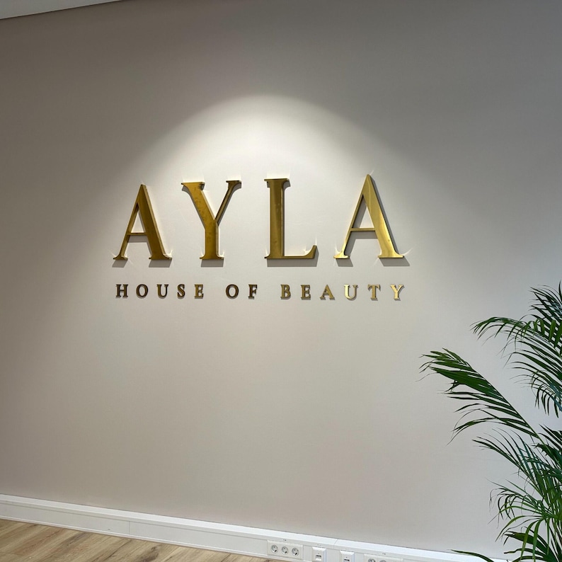 indoor sign.
made of stainless steel.
colour is brushed gold.
spaced 1 inch from wall.
letter thickness is 1 inch.