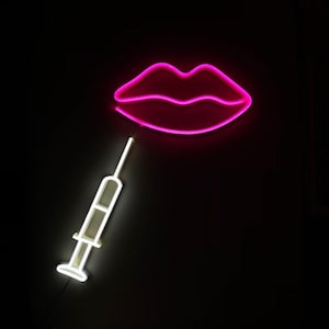 May include: A pink neon sign shaped like a pair of lips with a white neon sign shaped like a syringe underneath.