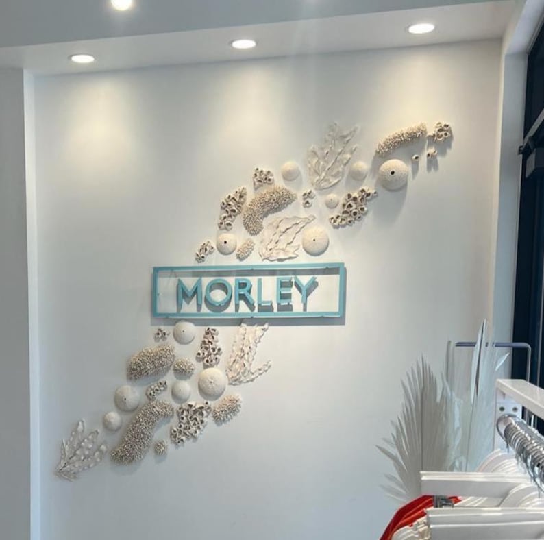 indoor sign.
made of stainless steel.
color is turquoise
1 inch from wall.
letter thickness is 1 inch.