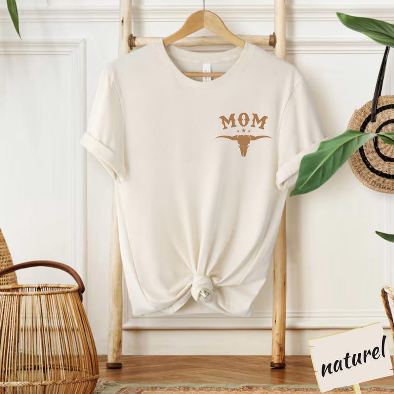 a white t - shirt with a cow skull on it