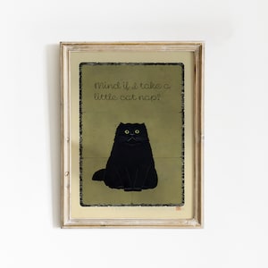 May include: Framed art print with a black cat illustration on a green backdrop. The text reads "Mind if I take a little cat nap?" above the cat. The frame is a light, neutral colour, suitable for home decor.