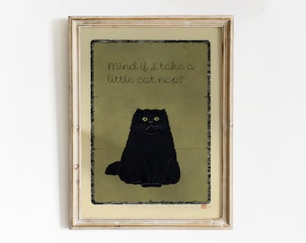 May include: Framed art print featuring a black cat with yellow eyes on a green background. The text "Mind if I take a little cat nap?" is written above the cat. The frame is a light, neutral color.