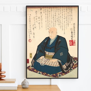 May include: A vintage Japanese woodblock print depicting a man in traditional clothing. The print is in black, white, and red, and features Japanese text. The man is seated on a cushion and holding a string of beads.