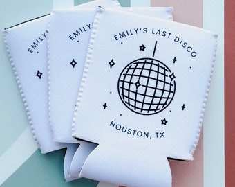 May include: Three white can coolers with black text and a disco ball graphic. The text reads "Emily's Last Disco" and "Houston, TX".