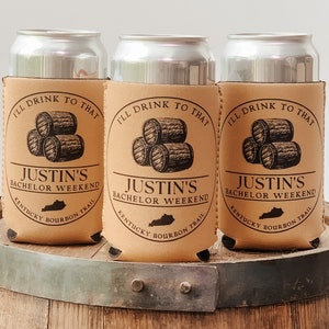 May include: Three brown koozies with a design of stacked barrels and the text "I'll drink to that Justin's Bachelor Weekend Kentucky Bourbon Trail".