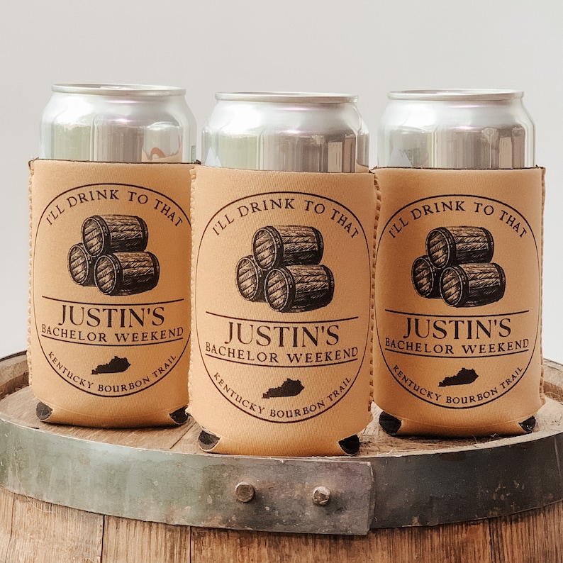 May include: Three brown koozies with a design of stacked barrels and the text "I'll drink to that Justin's Bachelor Weekend Kentucky Bourbon Trail".