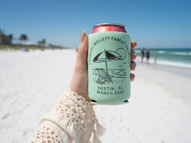 Puede incluir: Un enfriador de latas verde claro con un dise&ntilde;o de playa en blanco y negro, que incluye una sombrilla y una silla. El texto dice "CHIMENTI-MELLETT FAMILY VACATION DESTIN, FL MARCH 2026". El enfriador se sostiene en una playa soleada.
