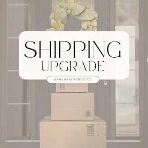 May include: Three brown cardboard boxes stacked on a doorstep with a white sign that says "SHIPPING UPGRADE" and the text "@THEMAKERSNESTCO" below.