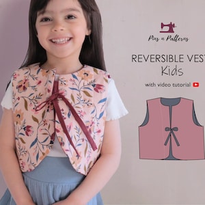 May include: A reversible vest for kids with a floral pattern in pink, red, and green. The vest is tied with a burgundy ribbon. The image also includes a diagram of the vest and the text "REVERSIBLE VEST Kids with video tutorial".