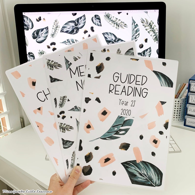 May include: Three white binders with a tropical leaf and abstract pattern. The front binder says "Guided Reading" with the text "Year 2J 2020".