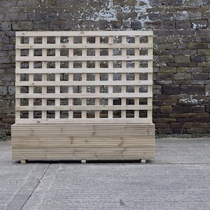 May include: A wooden lattice panel with a planter box underneath. The lattice is made of natural wood and has a square grid pattern. The planter box is also made of natural wood and has a horizontal slat design.