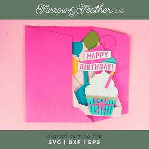 May include: A pink card with a pop-up cupcake and balloons. The cupcake is decorated with a pink bow and the balloons are blue, yellow, and green. The card says "Happy Birthday!" in white letters.