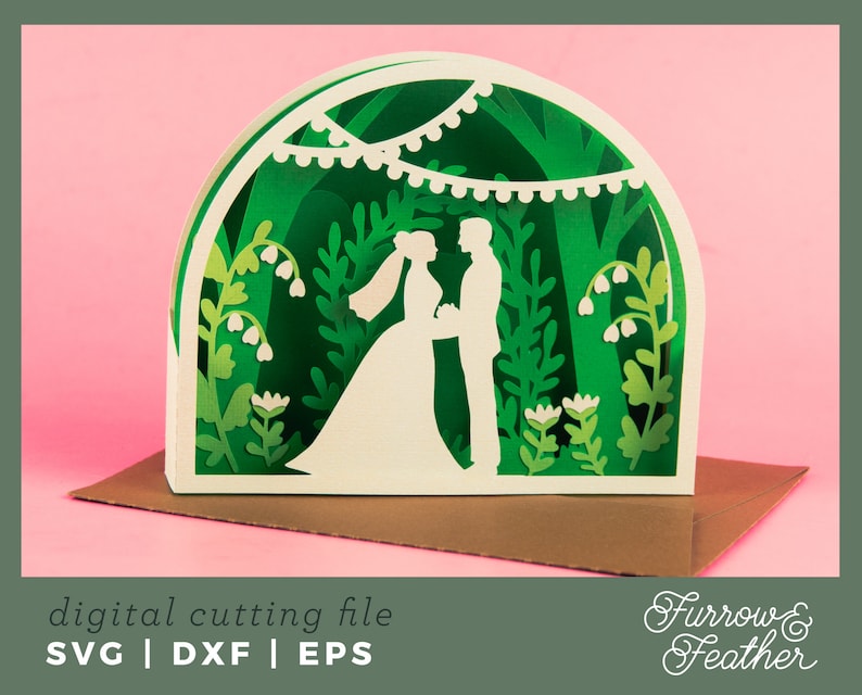 May include: A digital cutting file for a wedding card featuring a couple standing under a leafy archway with white flowers and string lights. The file is available in SVG, DXF, and EPS formats.  The text "Furrow & Feather" is in the bottom right corner of the image.