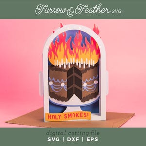 May include: A layered paper art card featuring a chocolate cake with flames and the text "HOLY SMOKES!". The card is set against a pink background, with the words "Furrow & Feather SVG" at the top and "digital cutting file SVG | DXF | EPS" at the bottom.
