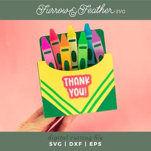 May include: A green and yellow card with a box of crayons and the words "Thank You!" in a white box. The card is perfect for a teacher or student.