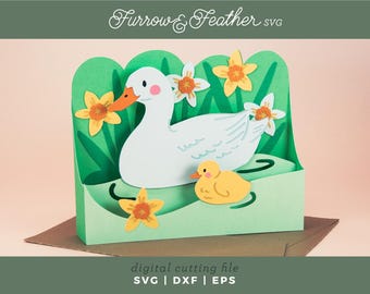 May include: A papercraft scene featuring a white duck with an orange beak and a yellow duckling, set against a green backdrop with yellow and white flowers. The design includes the text "Furrow & Feather SVG" and "digital cutting file SVG | DXF | EPS".